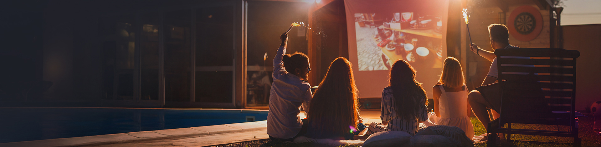 outdoor cinema, projector screen, group of people, bonfire spark, summer night